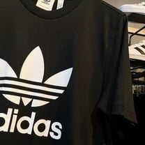 Adidas posts first loss in 30 years and warns on US