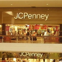 J.C. Penney's quarterly loss halves, set for full-year profit