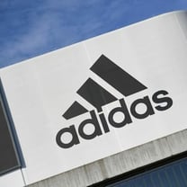 Adidas slumps as weak profit forecast follows currency hit