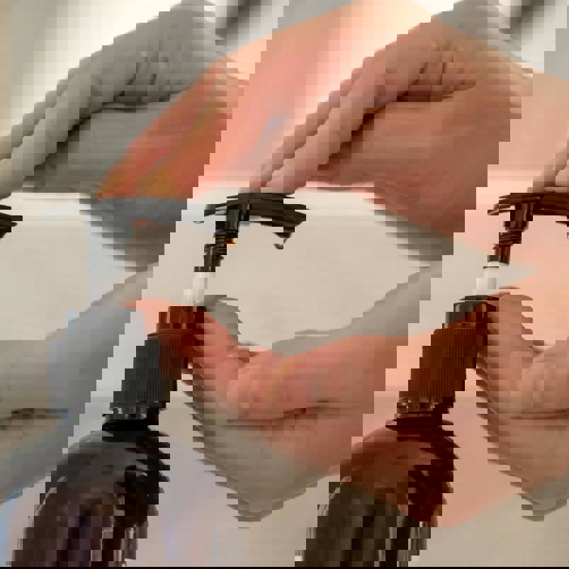 Person pumping handwash from a bottle